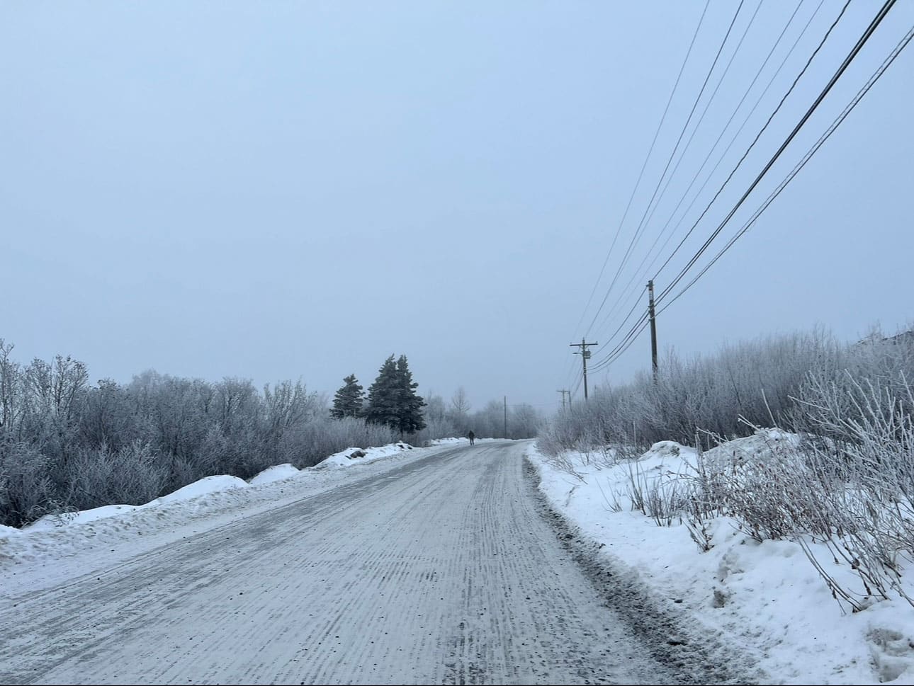 Man walking down a snowy road